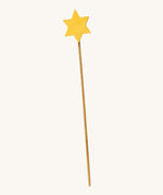 A wooden Ostheimer staff with a yellow star on the top for the Ostheimer angel on a cream background.
