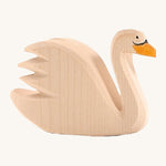 A wooden Ostheimer swan figure on a cream background.