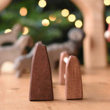 A side profile view of the Ostheimer large and small wooden toy fences placed next to each other on a wooden surface.  These wooden figures are part of a wide range of expertly hand crafted wooden toys here at Babipur. 
