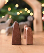 A side profile view of the Ostheimer large and small wooden toy fences placed next to each other on a wooden surface.  These wooden figures are part of a wide range of expertly hand crafted wooden toys here at Babipur. 