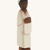 The Ostheimer hand carved wooden toy Nativity man figure, he wears simple cream robes and a hat.