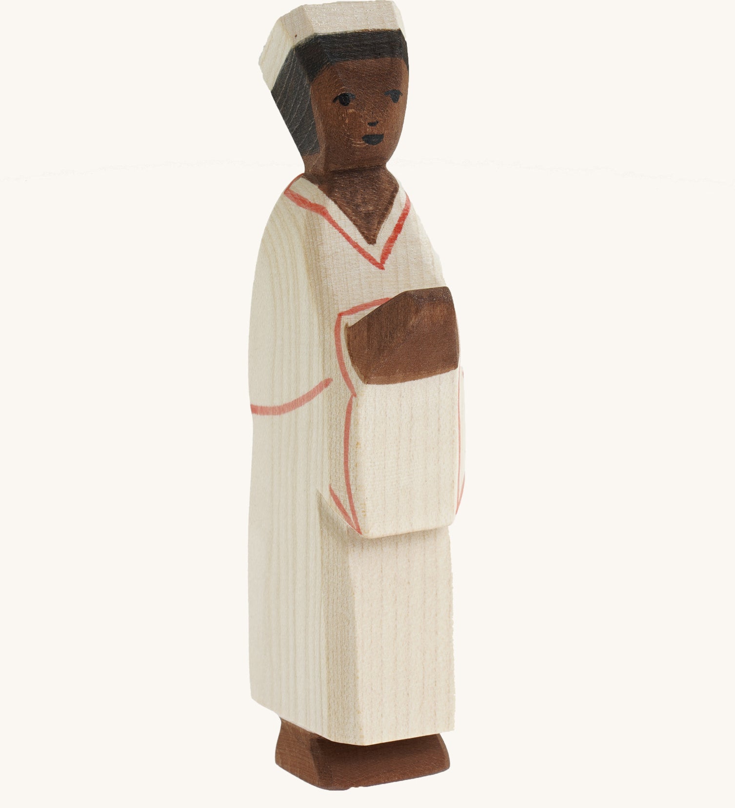 The Ostheimer hand carved wooden toy Nativity man figure, he wears simple cream robes and a hat.