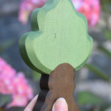 Ostheimer Wooden Oak Tree Figure being held up in an adult's hand to show scale.