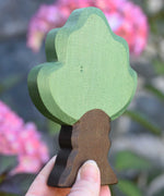 Ostheimer Wooden Oak Tree Figure being held up in an adult's hand to show scale.