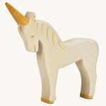 A white wooden Ostheimer unicorn figure on a cream background.