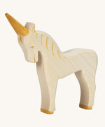 A white wooden Ostheimer unicorn figure on a cream background.