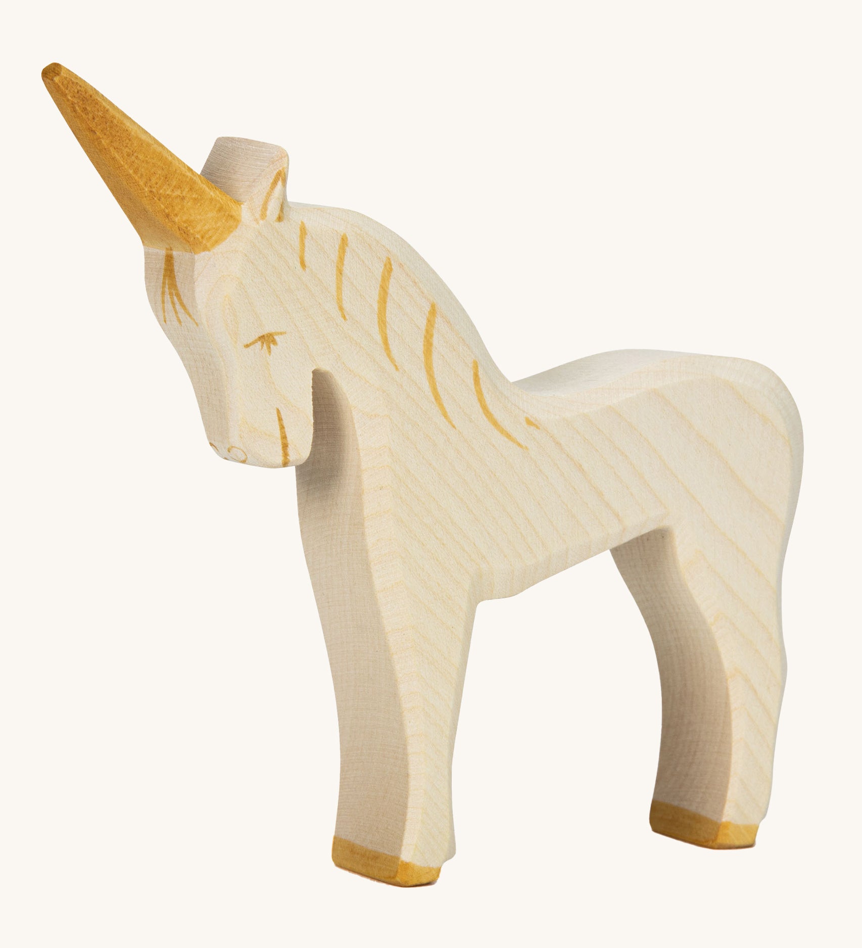 A white wooden Ostheimer unicorn figure on a cream background.