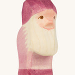 A violet wooden Ostheimer dwarf figure on a cream background.