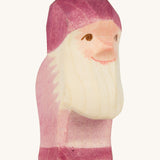 A violet wooden Ostheimer dwarf figure on a cream background.