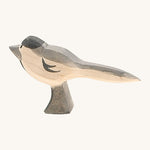 A wooden Ostheimer wagtail figure on a cream background