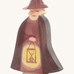 A wooden Ostheimer night watchman figure holding a lantern and wearing a purple cloak and matching purple hat on a cream background.