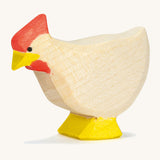 A white wooden standing Ostheimer hen on a cream background.