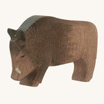 A wooden Ostheimer wild boar figure on a cream background.