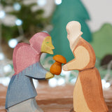 Ostheimer Witch and Noah wooden toy figures, handmade in Germany, exchanging a small mushroom gift, Waldorf and small world play scene, sold at Babipur