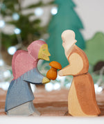 Ostheimer Witch and Noah wooden toy figures, handmade in Germany, exchanging a small mushroom gift, Waldorf and small world play scene, sold at Babipur
