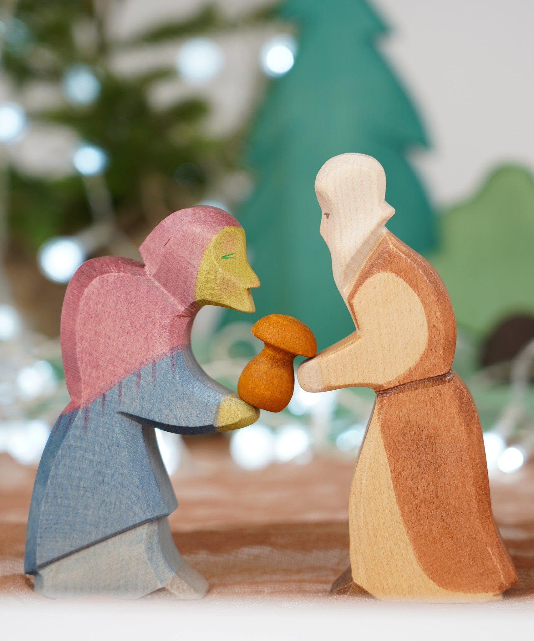 Ostheimer Witch and Noah wooden toy figures, handmade in Germany, exchanging a small mushroom gift, Waldorf and small world play scene, sold at Babipur