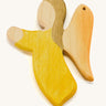 A yellow wooden angel figure on a cream background