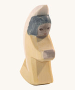 A yellow Ostheimer little angel wooden toy figure.