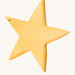 A yellow wooden star figure on a cream background