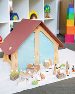 Ostheimer wooden farm house with light red roof and light blue doors
