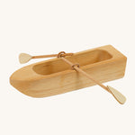 Ostheimer wooden lifeboat toy with paddles on a plain background.