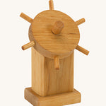 Ostheimer wooden toy boat steering wheel on a plain background.