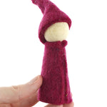 Close up of hand holding a Papoose rainbow gnome figure on a white background