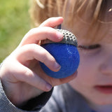 Blue Papoose Toys felt acorns in a child's hands.