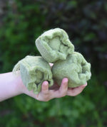 Papoose Toys felt cabbage in a set of three in a child's hands. 