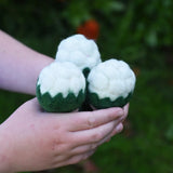 Papoose Toys felt cauliflower set of three in a child's hand.