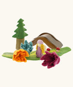 Papoose felted daffodil flowers used in a small world play scene with a wooden doll, tree and bridge in the background. 