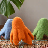 Three Papoose felted daffodil flowers placed upside down to look like a group of octupi.