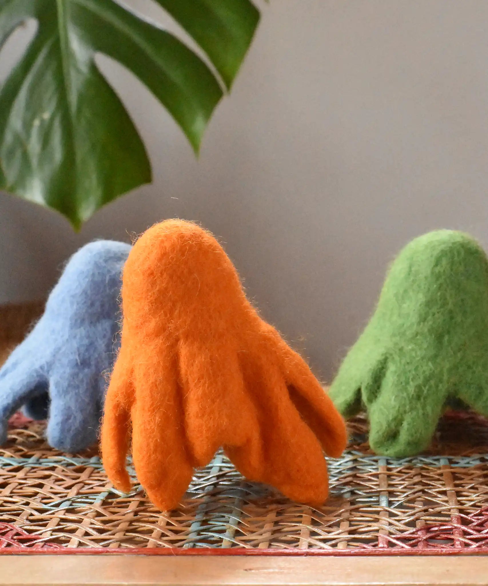 Three Papoose felted daffodil flowers placed upside down to look like a group of octupi.