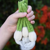 Papoose Toys felt garlic set in a set of three in a child's hand.