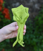 Papoose Toys felt lettuce in a child's hand.