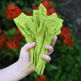 Papoose Toys felt lettuce set in a set of three in a child's hand.