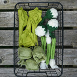 Papoose Toys felt vegetable play food placed in a black wire basket.