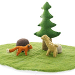 Papoose childrens fox and fawn toy figures on a green play mat next to a felt rock and tree