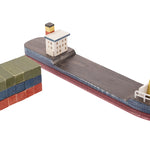 Papoose handmade wooden container ship model on a white background next to its wooden block cargo
