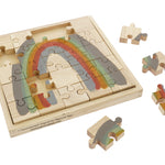 Pieces of the Papoose childrens earth rainbow jigsaw puzzle scattered around the wooden base on a white background