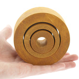 Close up of a hand holding the Papoose solid wooden nesting tube toys on a white background