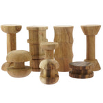 Papoose childrens stacking wooden spool toy blocks lined up on a white background