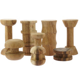 Papoose childrens stacking wooden spool toy blocks lined up on a white background