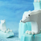 Felted white pom poms on wooden ice rock figures with wooden polar bear figures standing on the ice rocks.