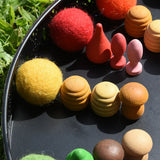 Close up of the Papoose felt balls placed in a mandala with Grapat mandala pieces. 