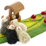 Papoose handmade sleepy mice toys huddled around a wooden wishing well on a green felt play mat