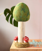 Papoose Toys Summer felt woodland tree placed on a rattan top stool. 