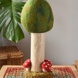 Papoose Toys Summer felt woodland tree placed on a rattan top stool. 