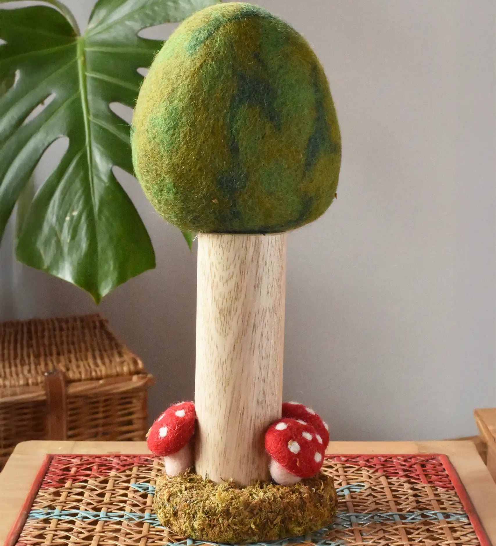 Papoose Toys Summer felt woodland tree placed on a rattan top stool. 