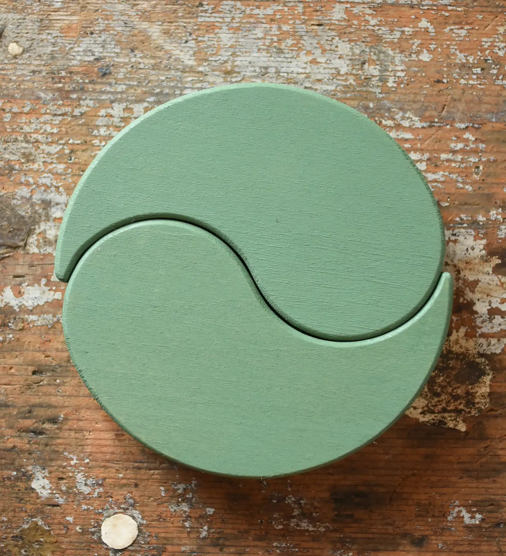 Papoose Toys wooden earth yim yams in green on a wooden desk. 
